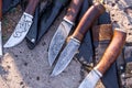 ÃÂ¡raft handmade hunting knives styled on damascus steel, are lying on the concrete floor